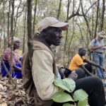 Severina, Damian, and Ezekeli are discussing with farip how they can generate a steady income from their forests, which are rich in biodiversity.